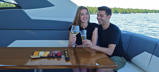 two people drinking a glass of wine on Cruisers Yachts boat