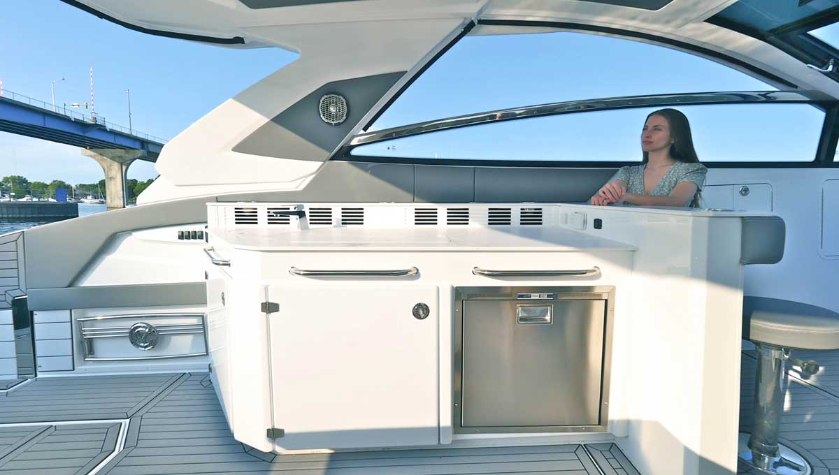 Woman sitting in 42 GLS OB cockpit galley