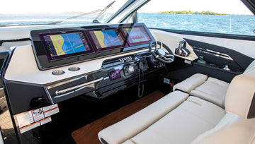 Cruisers Yachts helm dashboard with digital navigation screens and premium leather seating
